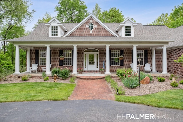 7149 Armadale Ct NE, Belmont, MI 49306 - view of front of property featuring a porch, brick siding, and roof with shingles