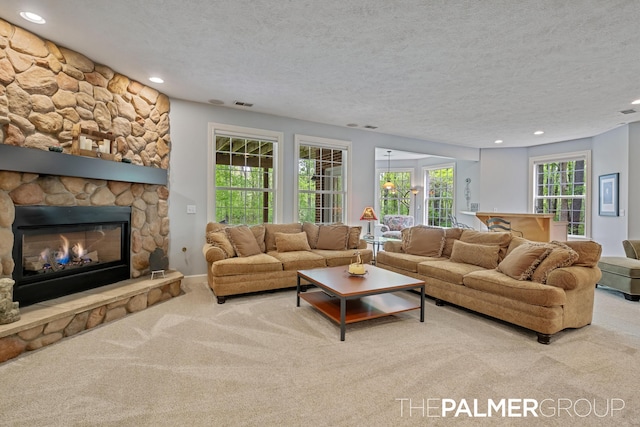 7149 Armadale Ct NE, Belmont, MI 49306 - carpeted living room with recessed lighting, a textured ceiling, and a fireplace