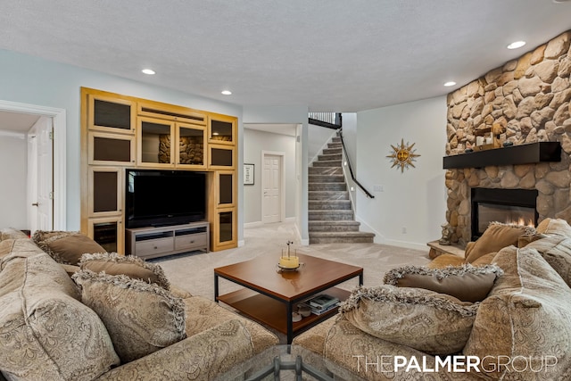 7149 Armadale Ct NE, Belmont, MI 49306 - living area featuring carpet floors, stairway, a stone fireplace, recessed lighting, and baseboards