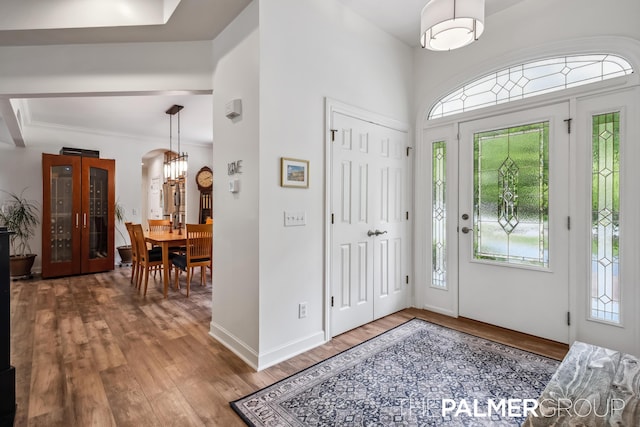 7149 Armadale Ct NE, Belmont, MI 49306 - foyer entrance featuring wood finished floors, healthy amount of natural light, and arched walkways