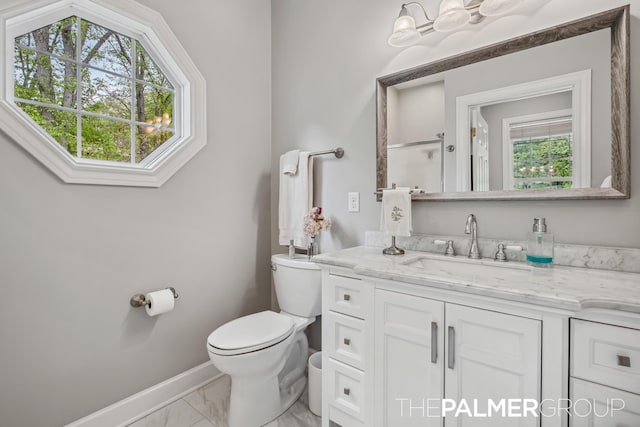 7149 Armadale Ct NE, Belmont, MI 49306 - bathroom with marble finish flooring, toilet, vanity, and baseboards