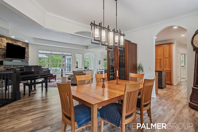 7149 Armadale Ct NE, Belmont, MI 49306 - dining space featuring arched walkways, light wood finished floors, ornamental molding, and recessed lighting