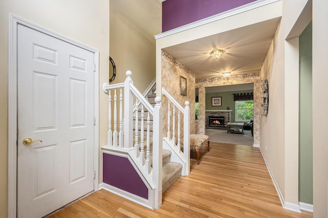 3311 Hickory Dr, Lake Orion, MI 48359 - staircase featuring wood finished floors, baseboards, and a stone fireplace