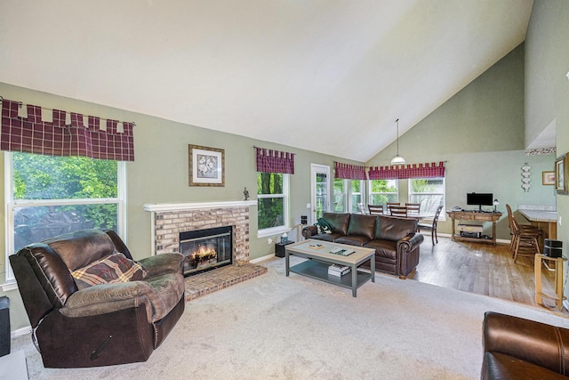 3311 Hickory Dr, Lake Orion, MI 48359 - living room with high vaulted ceiling, a brick fireplace, baseboards, and carpet flooring