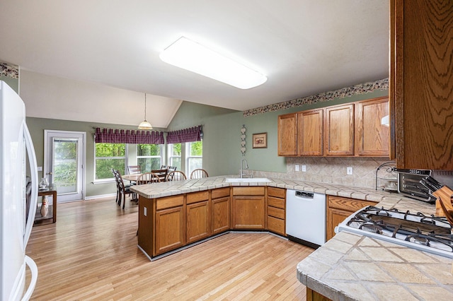 3311 Hickory Dr, Lake Orion, MI 48359 - kitchen with white appliances, a peninsula, a sink, light wood-style floors, and brown cabinets