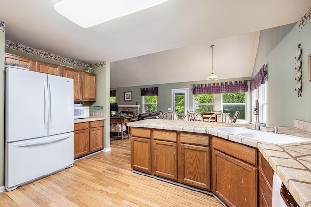 3311 Hickory Dr, Lake Orion, MI 48359 - kitchen with white appliances, a sink, brown cabinets, light wood-type flooring, and decorative light fixtures