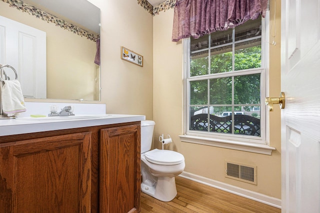 3311 Hickory Dr, Lake Orion, MI 48359 - half bathroom with baseboards, wood finished floors, vanity, and toilet