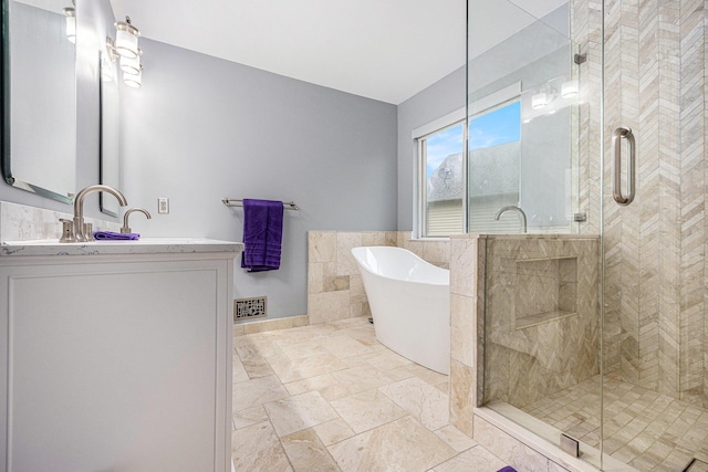 3311 Hickory Dr, Lake Orion, MI 48359 - full bathroom featuring vanity, a shower stall, a freestanding bath, and tile walls