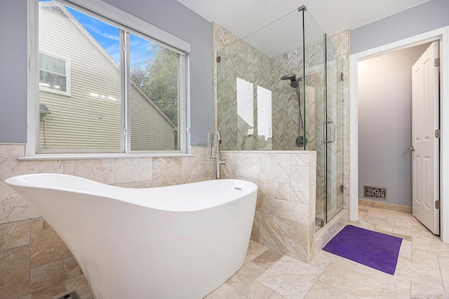3311 Hickory Dr, Lake Orion, MI 48359 - full bath featuring a soaking tub, a shower stall, tile walls, wainscoting, and marble finish flooring
