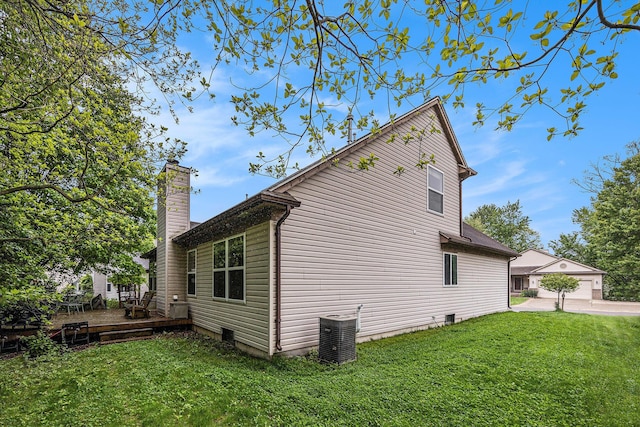 3311 Hickory Dr, Lake Orion, MI 48359 - view of property exterior with a deck, a yard, a chimney, and central air condition unit