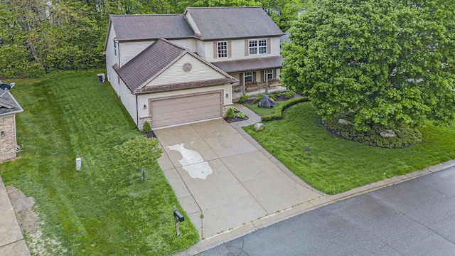 3311 Hickory Dr, Lake Orion, MI 48359 - traditional-style home with a front yard, concrete driveway, an attached garage, and a shingled roof
