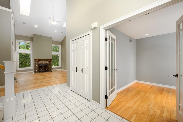 4936 Ravine Ct, Ann Arbor, MI 48105 - corridor with light wood-type flooring, a skylight, baseboards, recessed lighting, and lofted ceiling