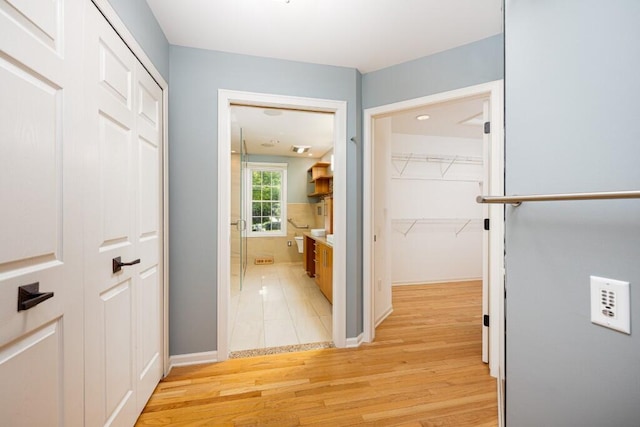 4936 Ravine Ct, Ann Arbor, MI 48105 - corridor with light wood-style floors and baseboards