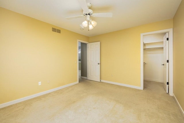 4936 Ravine Ct, Ann Arbor, MI 48105 - unfurnished bedroom with light colored carpet, baseboards, a ceiling fan, a walk in closet, and a closet