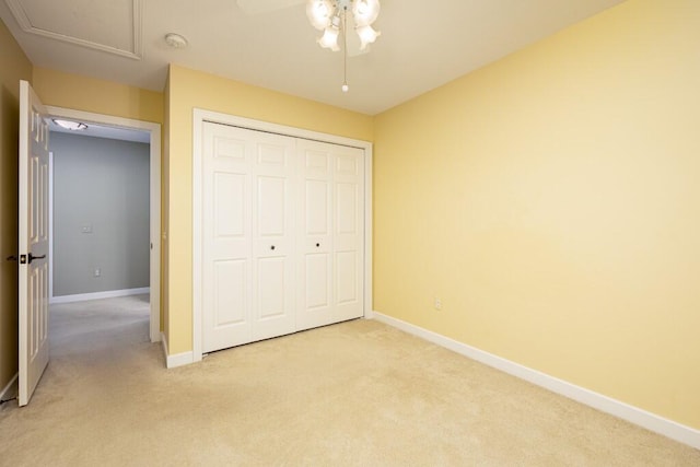 4936 Ravine Ct, Ann Arbor, MI 48105 - unfurnished bedroom featuring light colored carpet, baseboards, a closet, and a ceiling fan