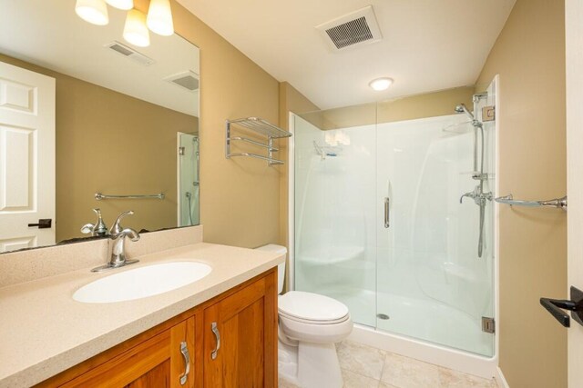 4936 Ravine Ct, Ann Arbor, MI 48105 - full bath featuring a shower stall, toilet, vanity, and tile patterned floors