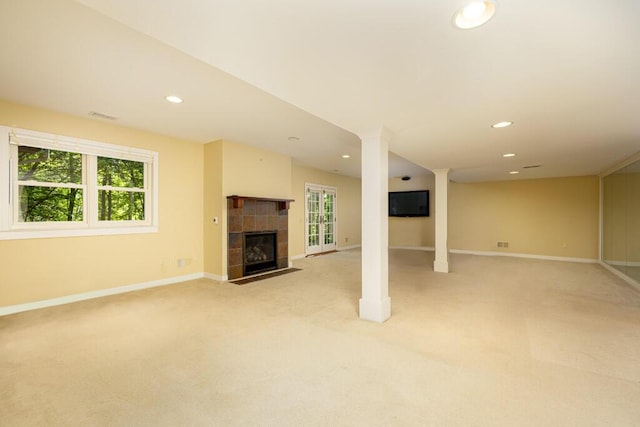 4936 Ravine Ct, Ann Arbor, MI 48105 - below grade area featuring light carpet, baseboards, a tiled fireplace, and recessed lighting