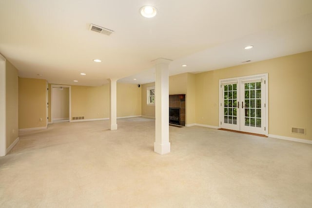4936 Ravine Ct, Ann Arbor, MI 48105 - below grade area with a tiled fireplace, recessed lighting, light carpet, and baseboards