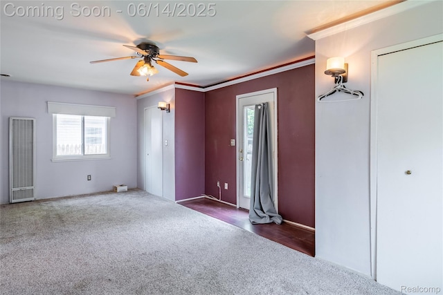 5633 Detroit St, Flat Rock, MI 48125 - unfurnished bedroom featuring a heating unit, carpet floors, multiple windows, a ceiling fan, and ornamental molding