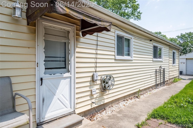 5633 Detroit St, Flat Rock, MI 48125 - view of exterior entry with a detached garage