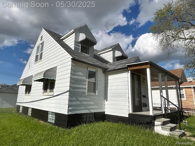 11005 Dodge Ave, Warren, MI 48089 - view of property exterior with a lawn and covered porch