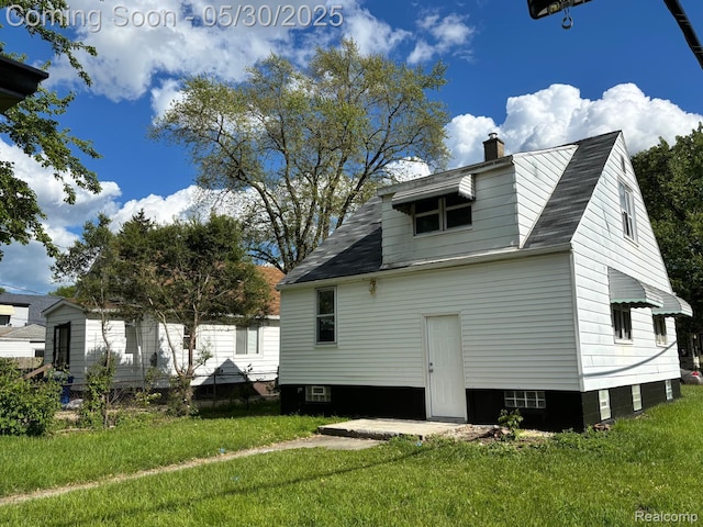 11005 Dodge Ave, Warren, MI 48089 - view of home's exterior with a lawn and a chimney