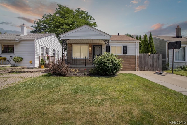 2562 Downing St, Melvindale, MI 48122 - view of front of property featuring a yard, a porch, and brick siding