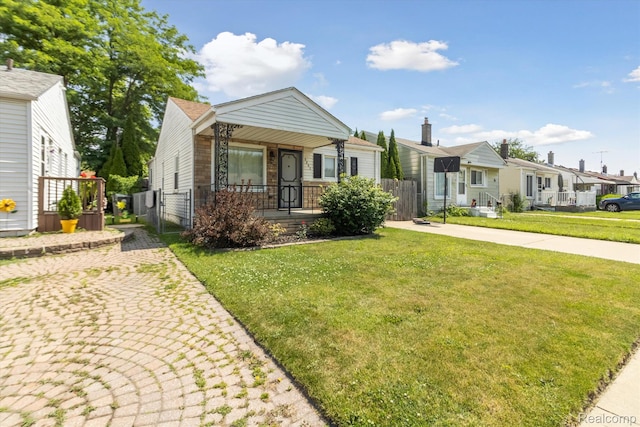 2562 Downing St, Melvindale, MI 48122 - view of front facade featuring a gate, covered porch, and a residential view