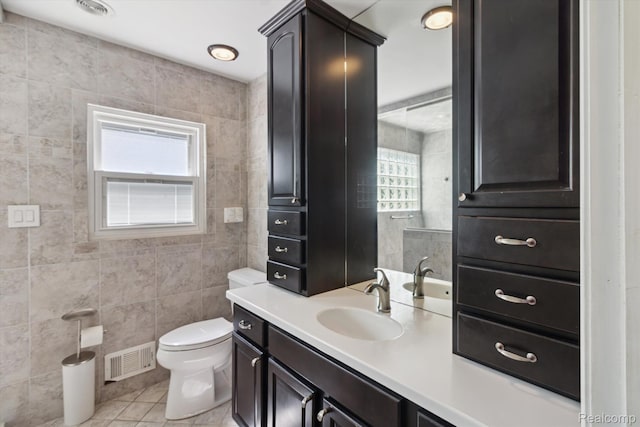2562 Downing St, Melvindale, MI 48122 - bathroom with tile patterned floors, tile walls, and vanity