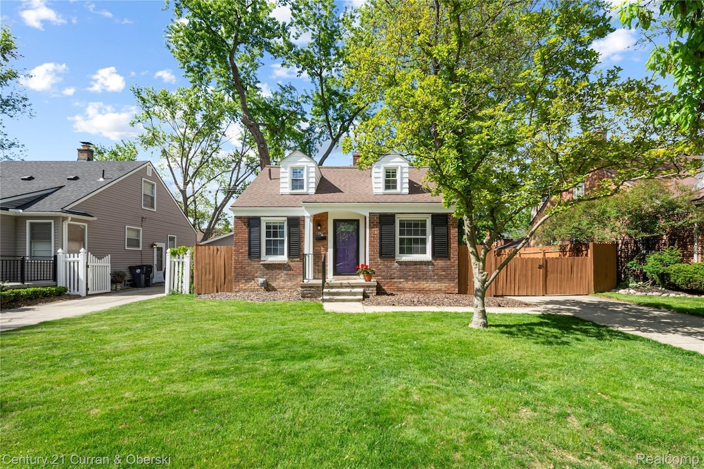 1392 Dorothea Rd, Berkley, MI 48072 - cape cod-style house with a gate, brick siding, and concrete driveway