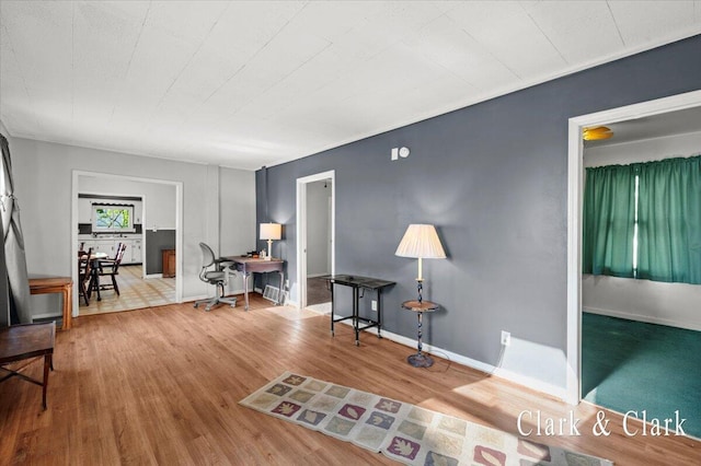 902 Turner Ave, Muskegon, MI 49442 - sitting room featuring an office area, wood finished floors, and baseboards