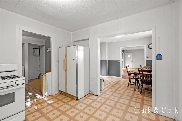 902 Turner Ave, Muskegon, MI 49442 - kitchen featuring white appliances, light floors, and crown molding