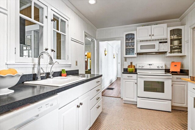 10251 Smith Rd, Union Pier, MI 49129 - kitchen with white appliances, crown molding, a sink, dark countertops, and glass insert cabinets