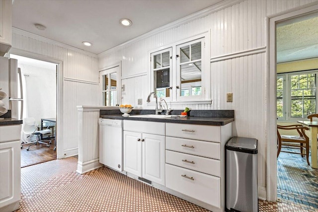 10251 Smith Rd, Union Pier, MI 49129 - kitchen with white dishwasher, a sink, crown molding, white cabinetry, and dark countertops