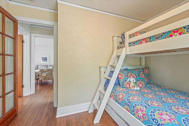 10251 Smith Rd, Union Pier, MI 49129 - bedroom with wood finished floors, crown molding, a textured wall, a textured ceiling, and baseboards