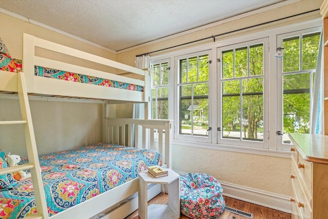 10251 Smith Rd, Union Pier, MI 49129 - bedroom with baseboards, wood finished floors, a textured ceiling, and ornamental molding