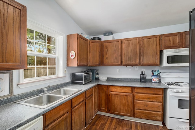2305 Hester Ct, Keego Harbor, MI 48320 - kitchen with white appliances, a sink, lofted ceiling, dark wood-type flooring, and brown cabinets