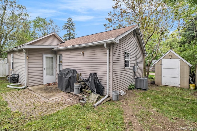 2305 Hester Ct, Keego Harbor, MI 48320 - back of property featuring central air condition unit, roof with shingles, and a patio area