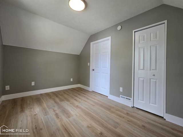 532 Grover St, Owosso, MI 48867 - additional living space featuring vaulted ceiling, light wood-type flooring, and baseboards