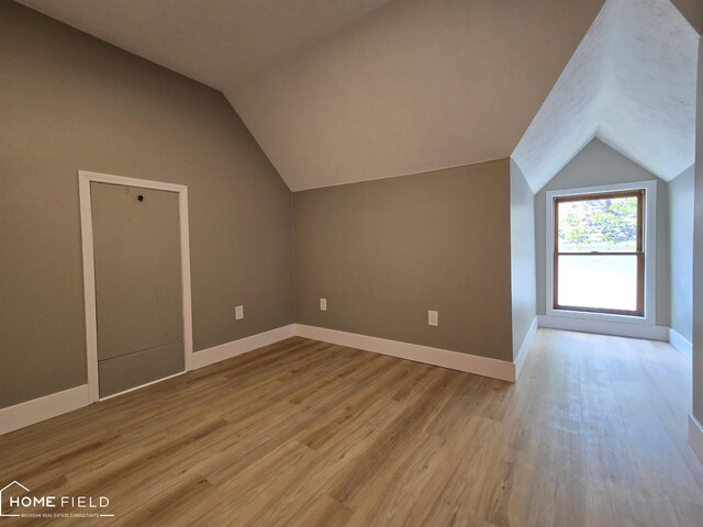 532 Grover St, Owosso, MI 48867 - bonus room featuring vaulted ceiling, wood finished floors, and baseboards