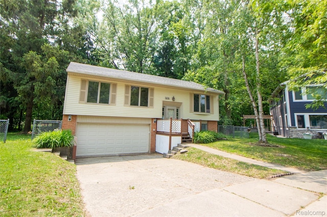 2626 Winter Dr, Troy, MI 48083 - bi-level home with brick siding, concrete driveway, an attached garage, and view of scattered trees