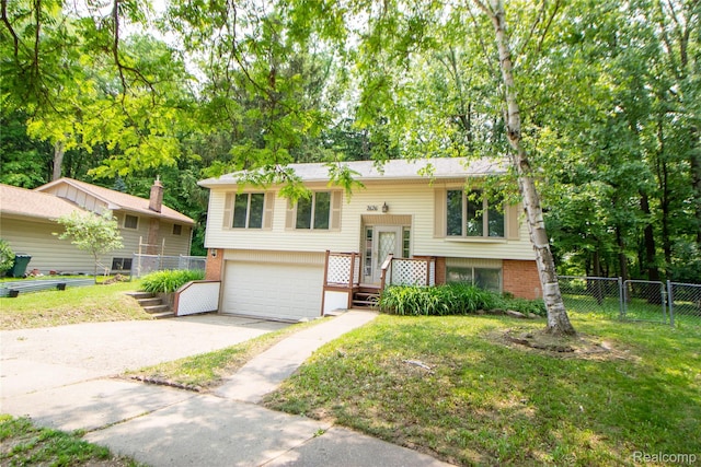 2626 Winter Dr, Troy, MI 48083 - raised ranch featuring brick siding, a garage, driveway, and a gate