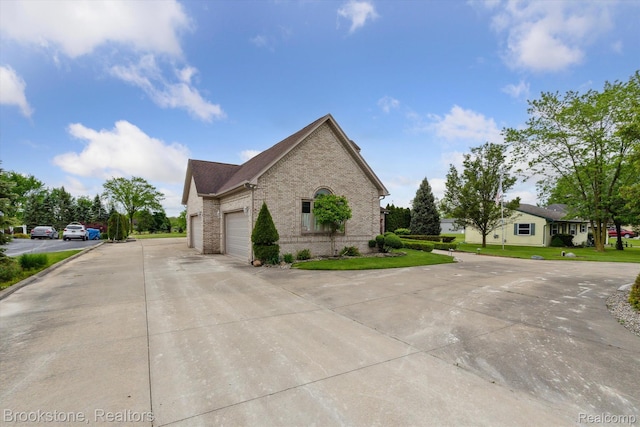 27820 29 Mile Rd, Lenox, MI 48048 - view of property exterior with brick siding, concrete driveway, an attached garage, and a yard