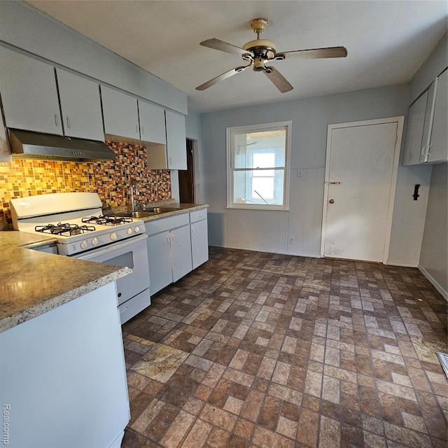 2007 Evaline St, Hamtramck, MI 48212 - kitchen with under cabinet range hood, white gas range, a sink, tasteful backsplash, and ceiling fan