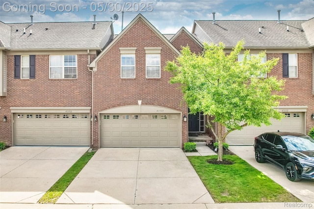 41342 N Maplewood Dr, Canton, MI 48187 - townhome / multi-family property featuring a garage, brick siding, driveway, and roof with shingles