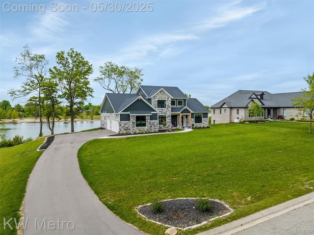 1585 Kriss Crossing Rd, Brighton, MI 48114 - craftsman-style house featuring stone siding, a water view, asphalt driveway, a front lawn, and a garage