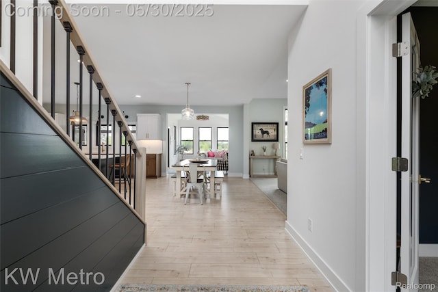 1585 Kriss Crossing Rd, Brighton, MI 48114 - foyer entrance with stairway, light wood-style flooring, and baseboards