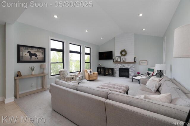 1585 Kriss Crossing Rd, Brighton, MI 48114 - living room with a glass covered fireplace, light wood-style flooring, recessed lighting, baseboards, and high vaulted ceiling