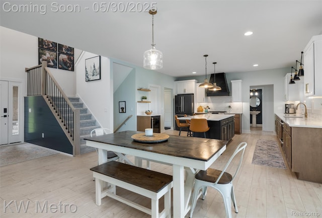 1585 Kriss Crossing Rd, Brighton, MI 48114 - dining area featuring light wood-style floors, stairs, recessed lighting, and wine cooler