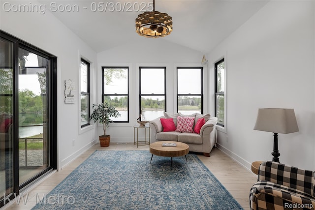1585 Kriss Crossing Rd, Brighton, MI 48114 - living area with vaulted ceiling, baseboards, and a water view